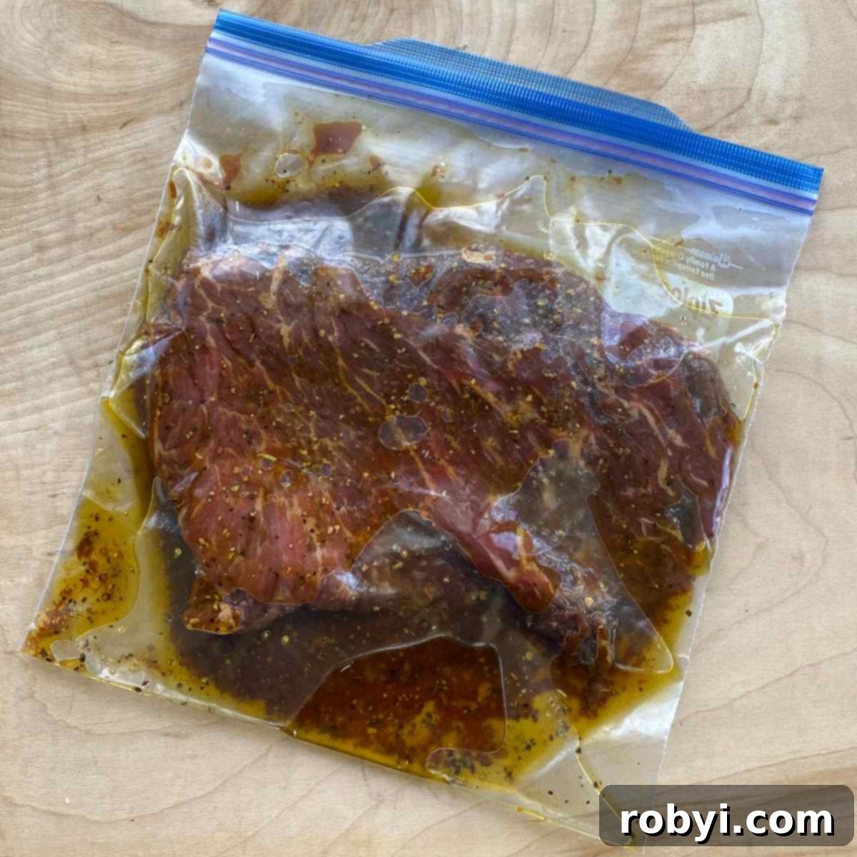 Bavette steak meat marinating in a plastic bag.