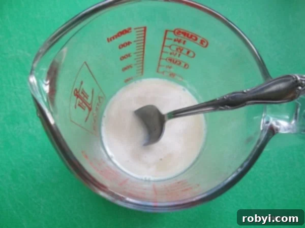 Dissolved yeast mixture for pretzel bites in bowl.