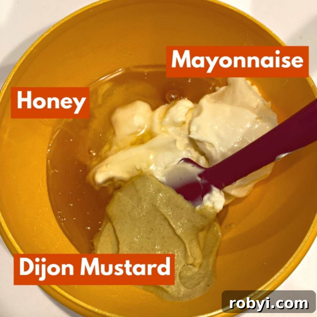 Ingredients for homemade honey mustard sauce: Mayonnaise, Dijon mustard, and golden honey in separate bowls.