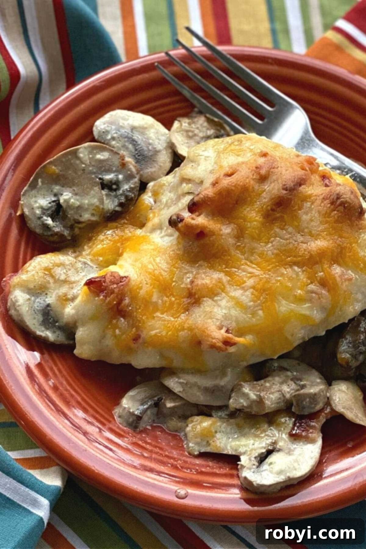 Homemade Alice Springs Chicken on a white plate, served with extra sautéed mushrooms on the side.