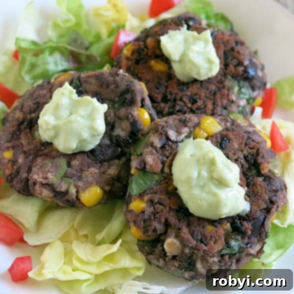 Flavorful Black Bean Cakes topped with a dollop of fresh Avocado Cream
