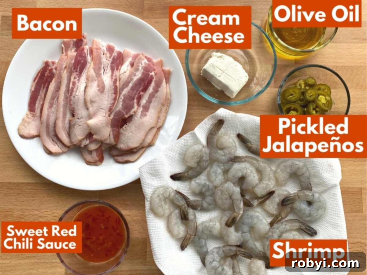 Clearly labeled ingredients laid out on a clean surface to make bacon wrapped shrimp stuffed with cream cheese and jalapenos.