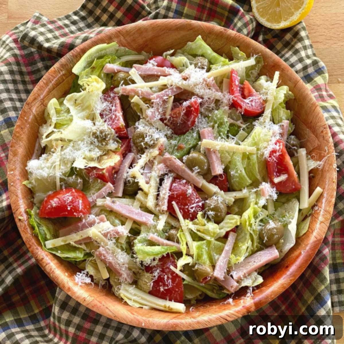 Columbia 1905 Salad with ham, cheese, green olives, and tomatoes and garlic vinaigrette dressing in a bowl.