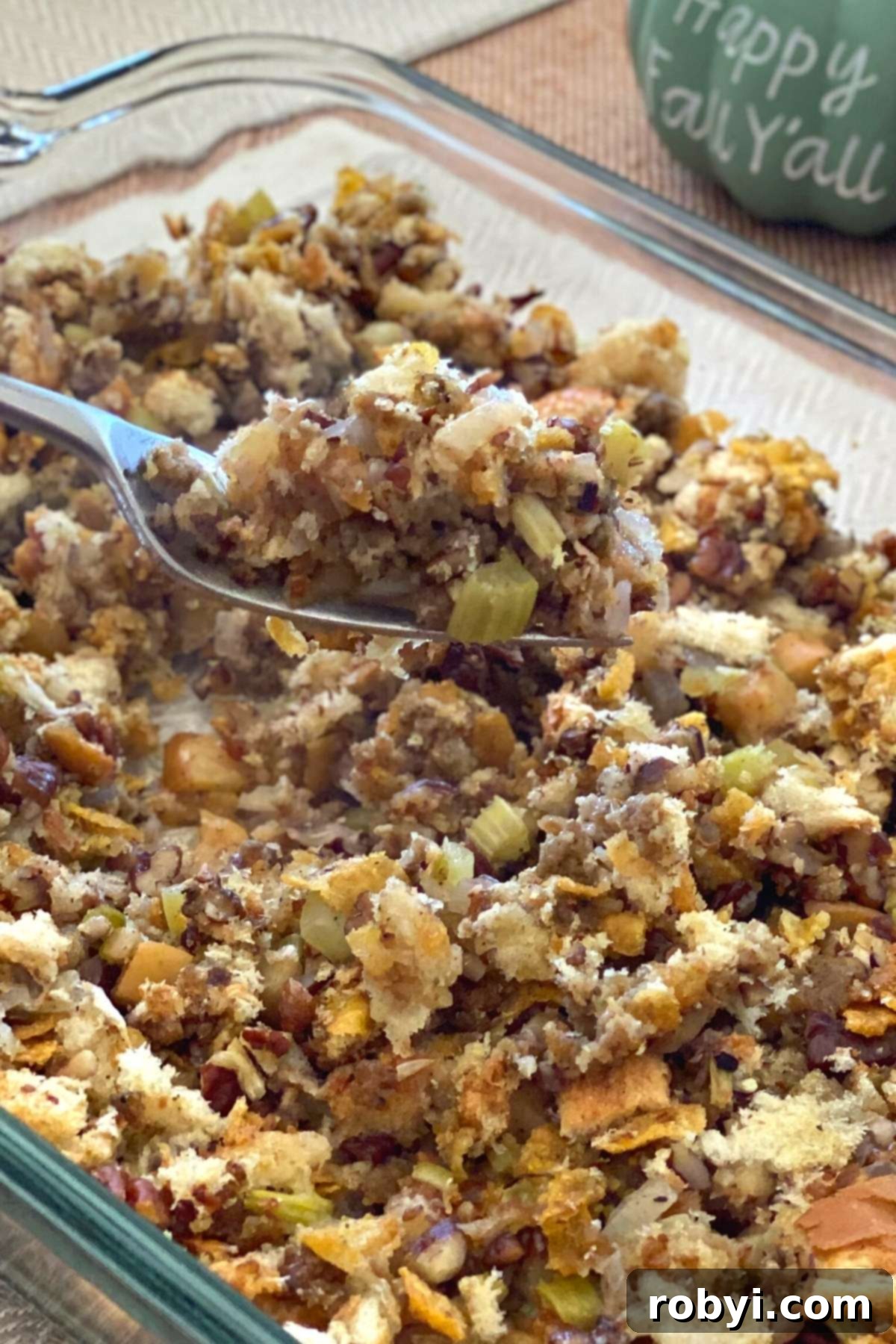 Prep-Ahead Oven Stuffing 2 Golden brown make-ahead Oven Baked Stuffing, prepared with fresh bread, diced apples, and chopped pecans, served in a rustic casserole dish.