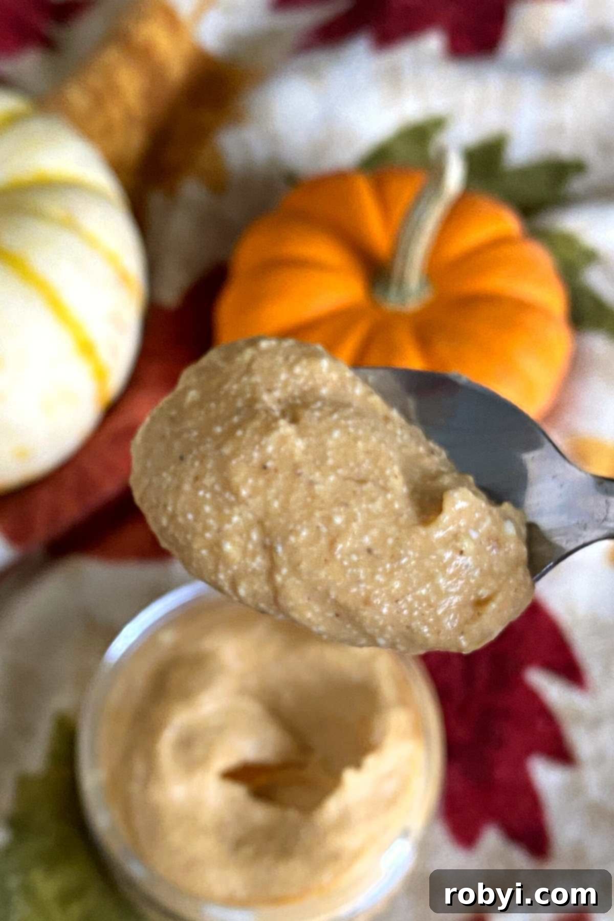 A spoonful of smooth whipped pumpkin cottage cheese, showcasing its creamy texture.