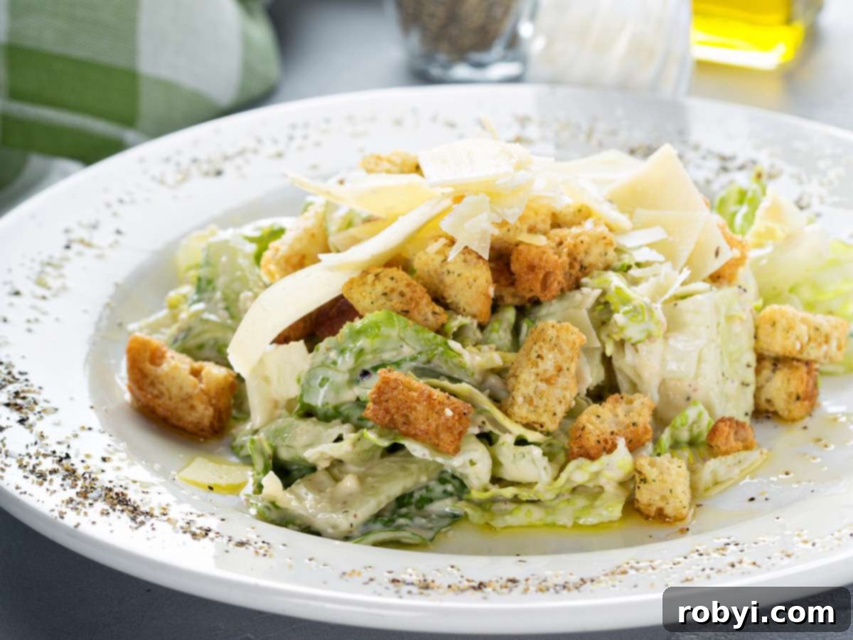A classic Caesar salad elegantly arranged on a plate.
