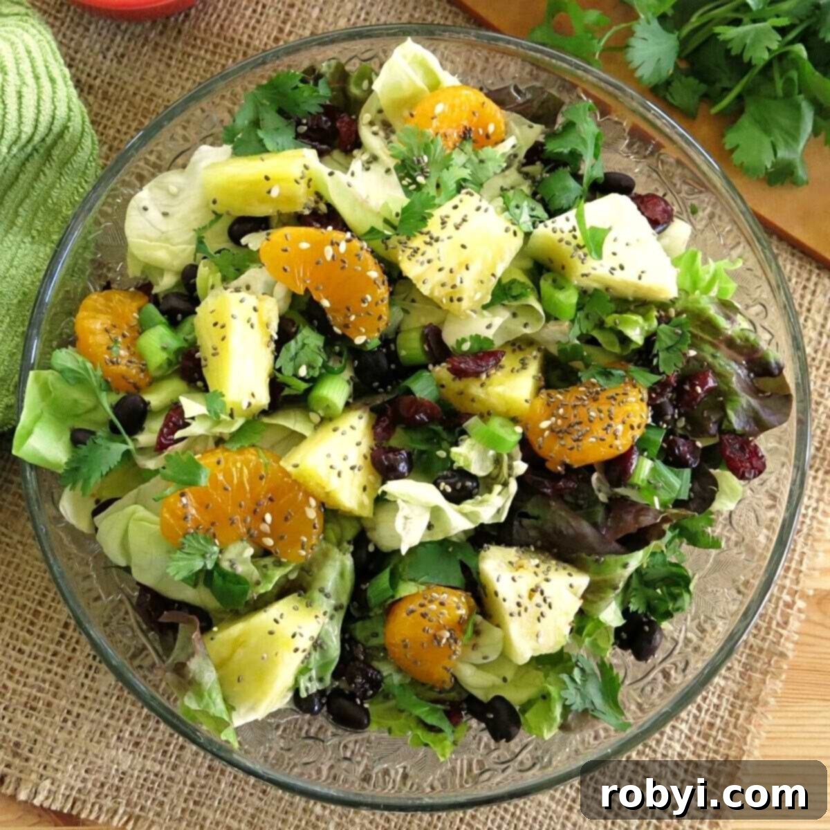 A vibrant Caribbean salad with honey lime dressing, served on a salad plate.