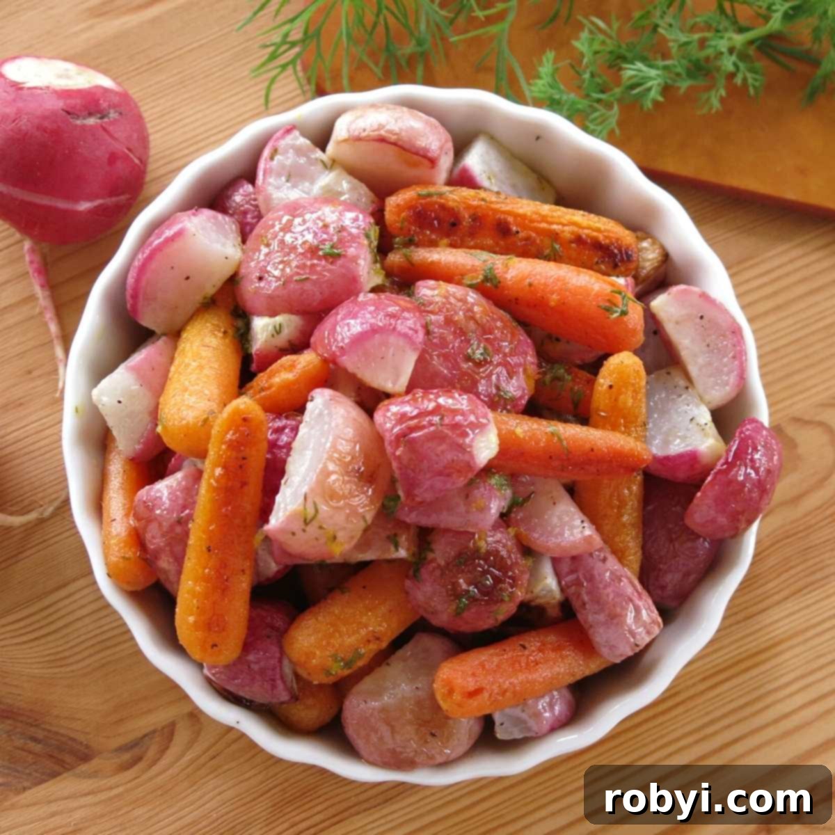 Roasted radishes and carrots bathed in a lemon butter dill sauce, served in a charming serving bowl.