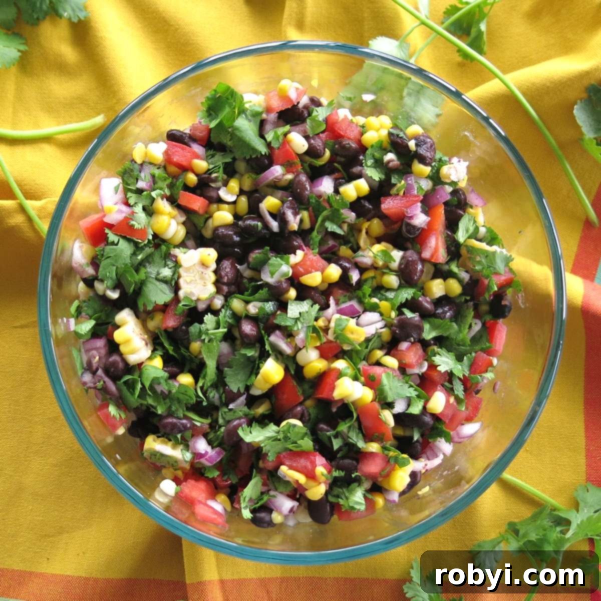 A vibrant bowl of corn and black bean salsa, garnished with fresh cilantro.