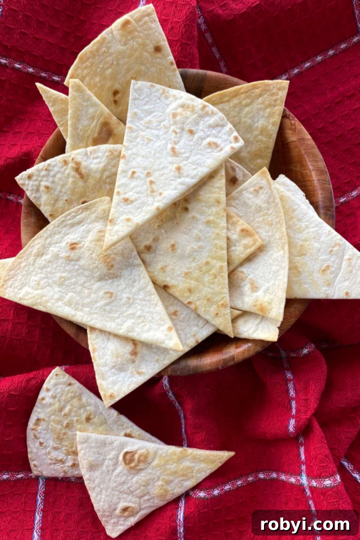 A rustic basket overflowing with freshly baked keto tortilla chips, ready for serving.