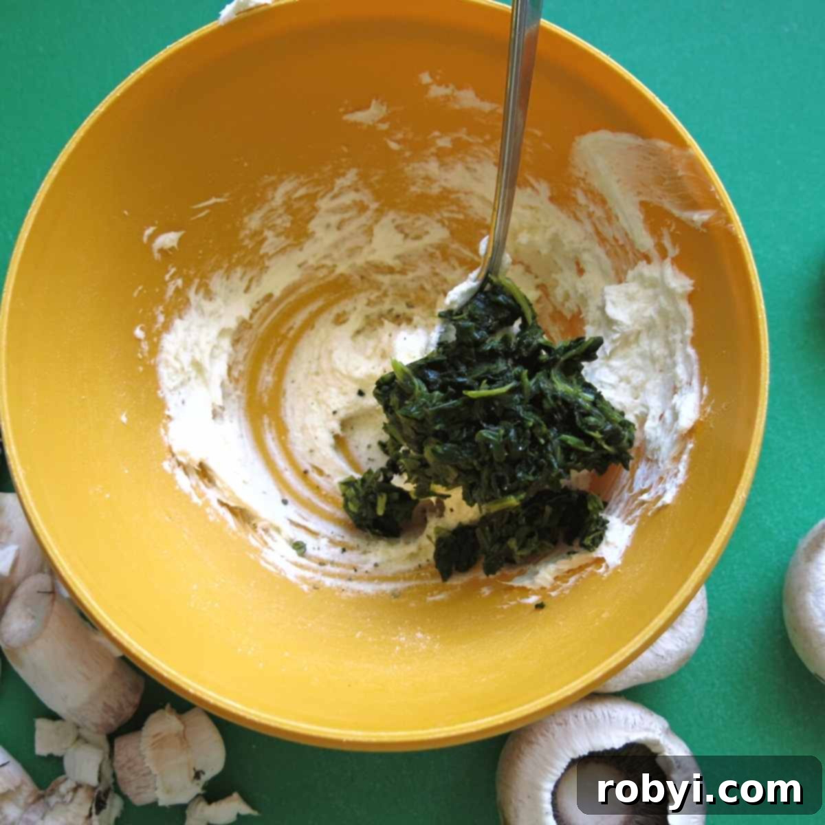 A bowl containing the creamy spinach and cream cheese mixture, ready for stuffing.