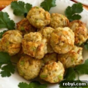 Baked crab balls piled into a white plate, ready to serve.