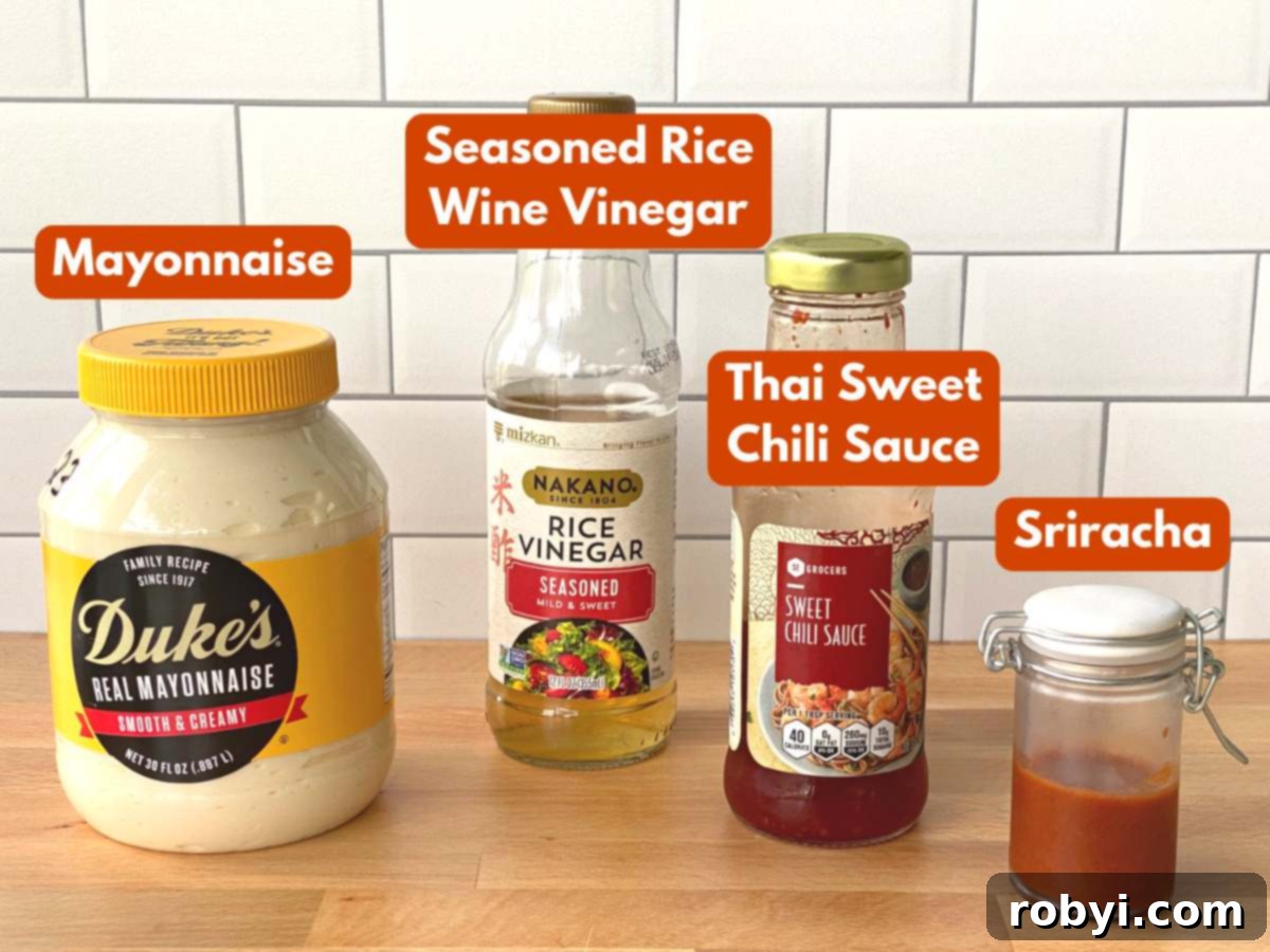 Bang bang sauce recipe ingredients: Mayonnaise, sweet chili sauce, sriracha, seasoned rice vinegar laid out on a white background.