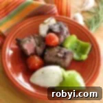 Plate with red wine marinated steak shish kabobs removed from skewers.