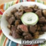 Air Fryer Steak Bites on plate with mushrooms and blue cheese dipping sauce