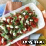 Roasted Grape Tomato Caprese Salad on a rectangular plate