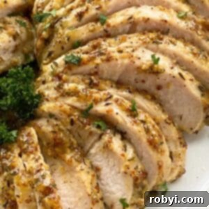 Slices of turkey tenderloin that have been marinated in a mixture of maple syrup, olive oil, stone ground dijon mustard, dried thyme leaves, salt, and pepper.