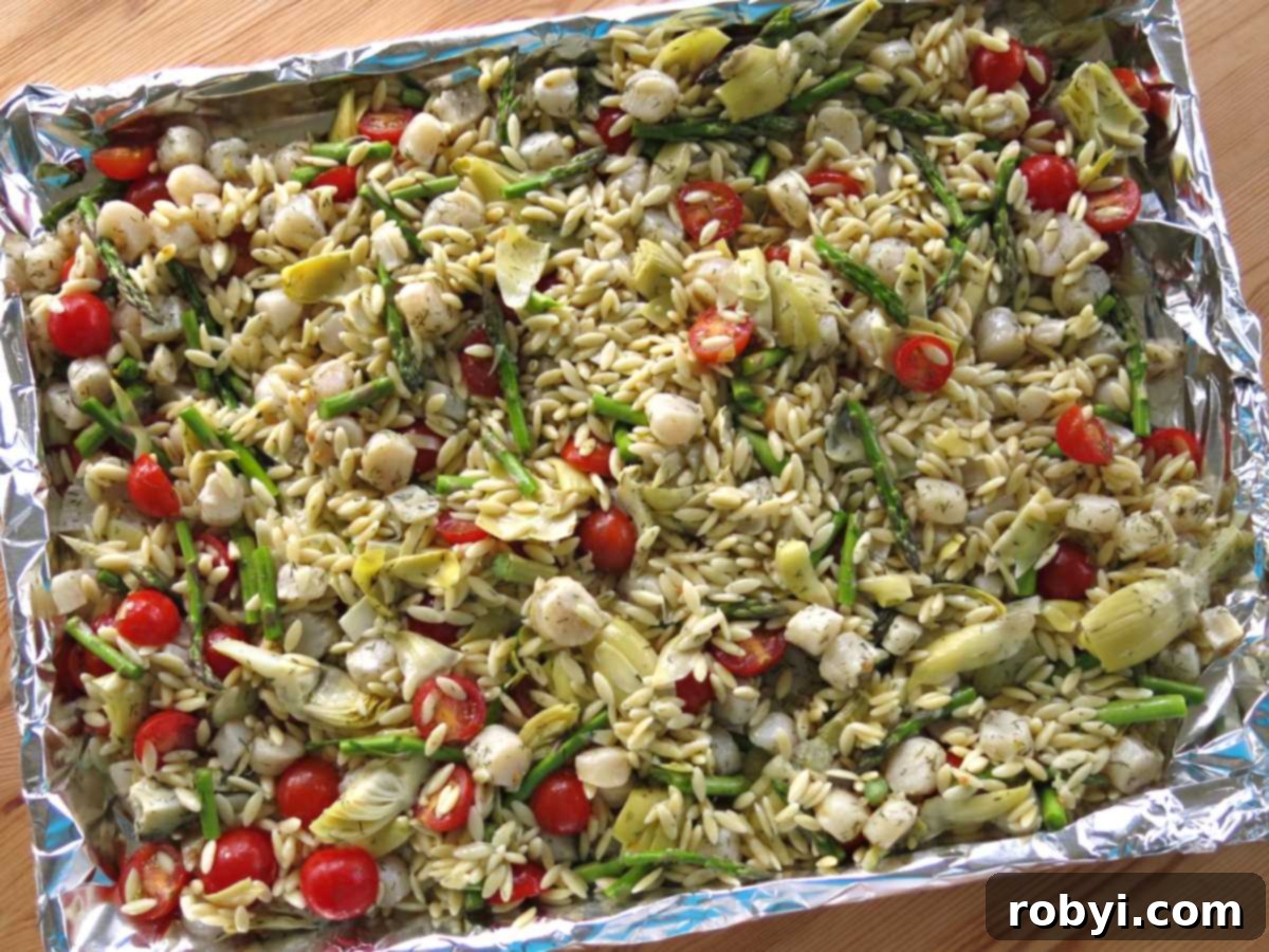 Pan-Seared Scallops over Warm Orzo with Marinated Artichokes and Feta 3 Warm orzo salad ingredients on a sheet pan before baking.