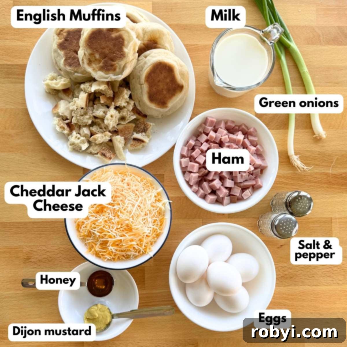 Ingredients needed for ham strata: English muffins (some bited sized pieces, some whole,) milk, green onions, diced ham, shredded cheddar jack cheese, 6 eggs, honey, Dijon mustard, salt and pepper shakers.