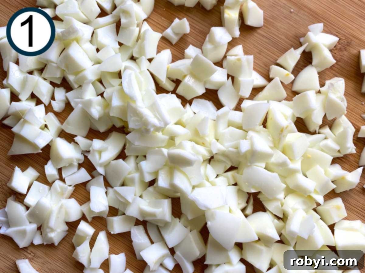 Bright and Light Egg Salad 4 Chopped egg whites on a cutting board.