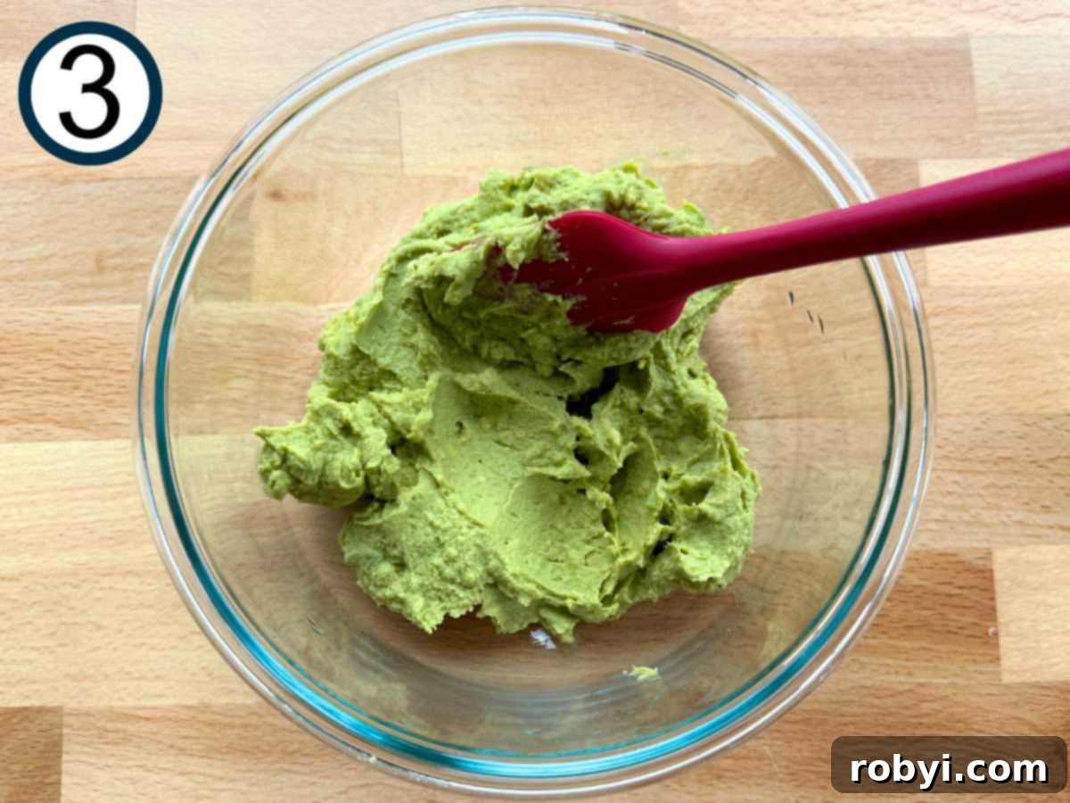 Bright and Light Egg Salad 6 Mashed avocado, apple cider vinegar, Dijon mustard, egg yolks, and salt mixed together in a bowl.