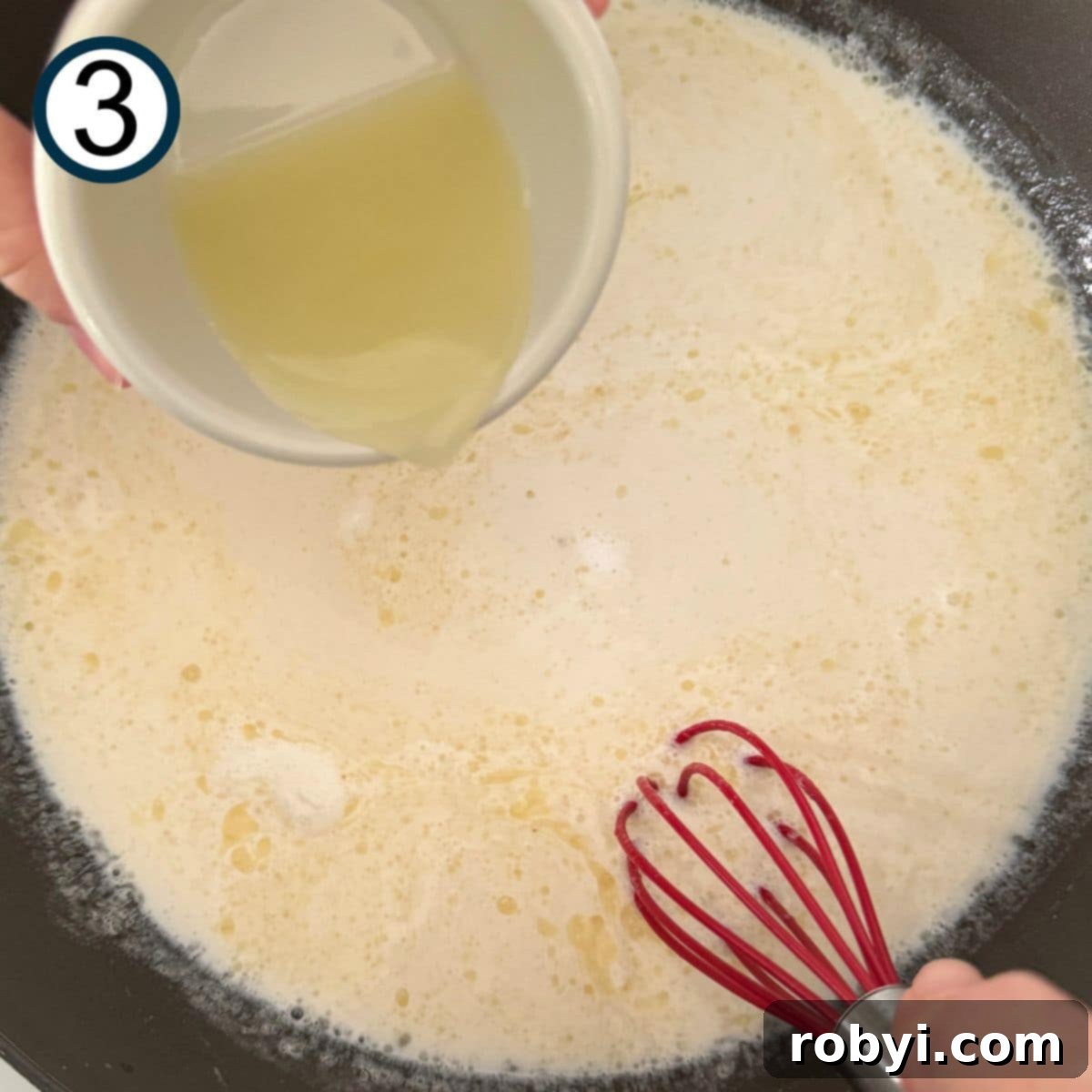 Lemon juice being poured into pan with broth, cream, and Parmesan.