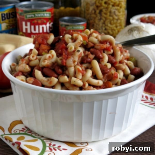Copycat Olive Garden Pasta Fagioli Soup 5 A large bowl of Pasta Fagioli Soup with a spoon, ready for a comforting meal.