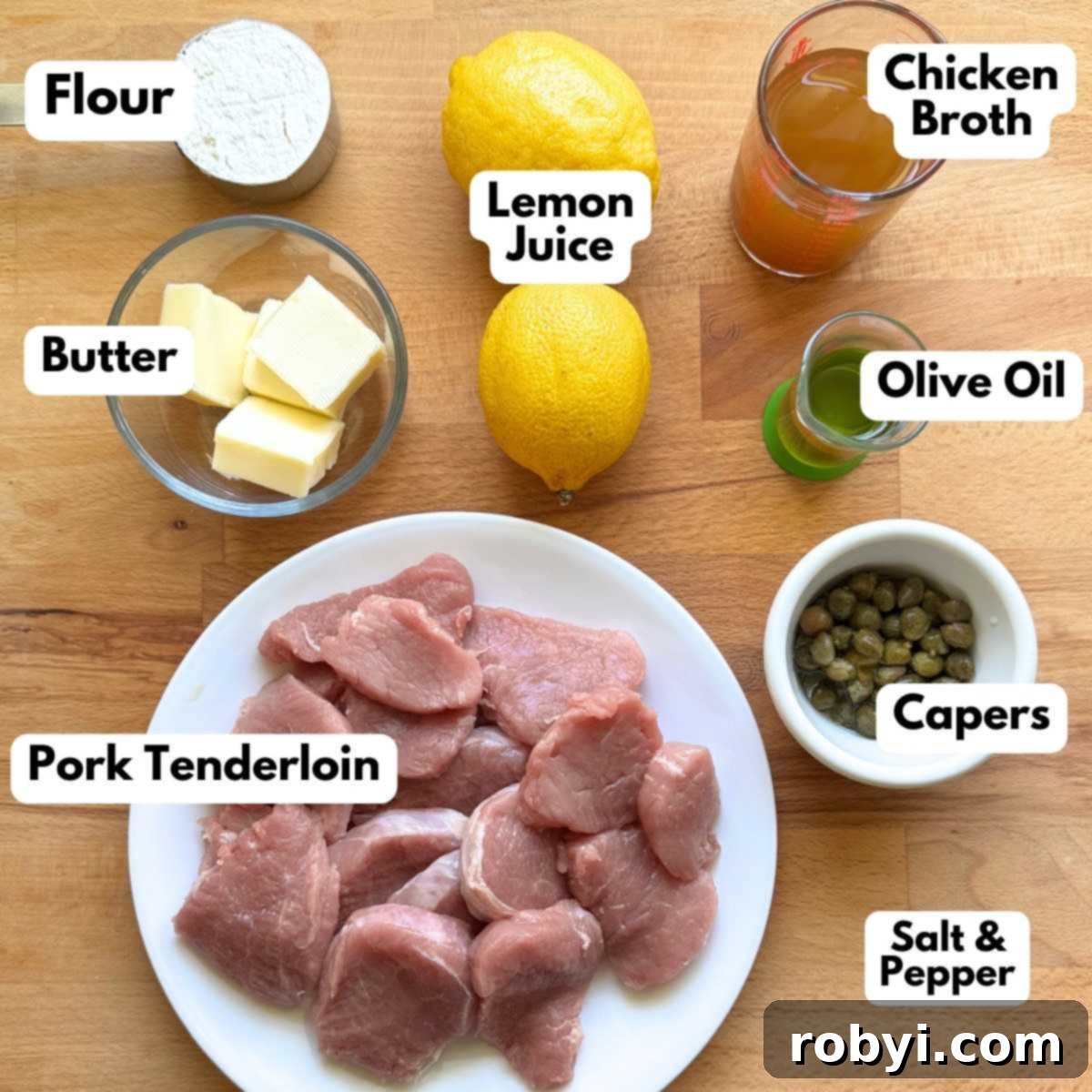 Labeled ingredients to make pork tenderloin piccata: flour, 2 lemons, chicken broth, 4 cubes of butter, olive oil, capers, pork tenderloin cut into medallions.