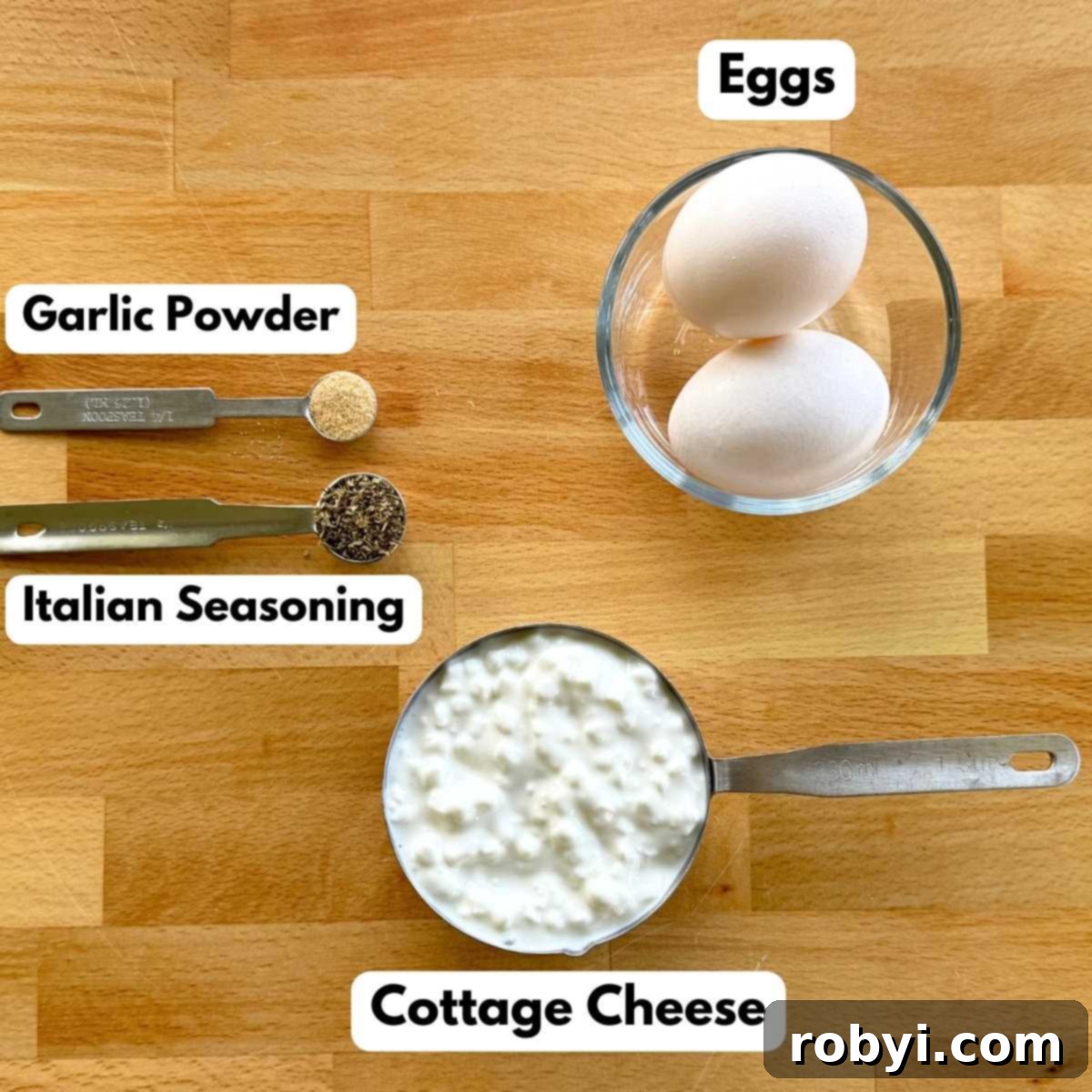 Ingredients to make cottage cheese flatbread: cottage cheese in a measuring cup, two eggs in a bowl, and Italian seasoning and garlic powder in measuring spoons.