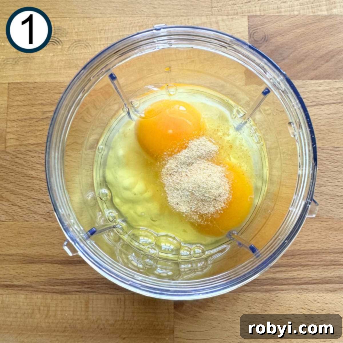 Cottage cheese, 2 eggs, and garlic powder in a personal blender before mixing.