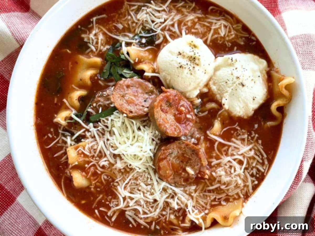 A comforting bowl of one-pot lasagna soup, elegantly topped with creamy dollops of ricotta cheese and fresh herbs, ready to be enjoyed.
