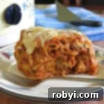 Host a Friendsgiving Feast for Less 6 Serving of crock-pot baked ziti with ricotta in front of a slow cooker.