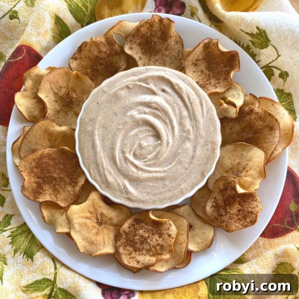 Homemade Crispy Apple Chips 7 Bowl of almond butter Greek yogurt dip surrounded by dried apple chips.