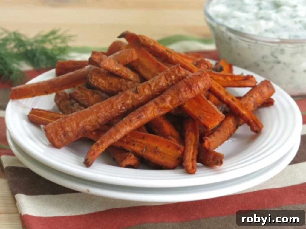 Crispy air fryer carrot fries neatly arranged on a white plate, ready for serving.