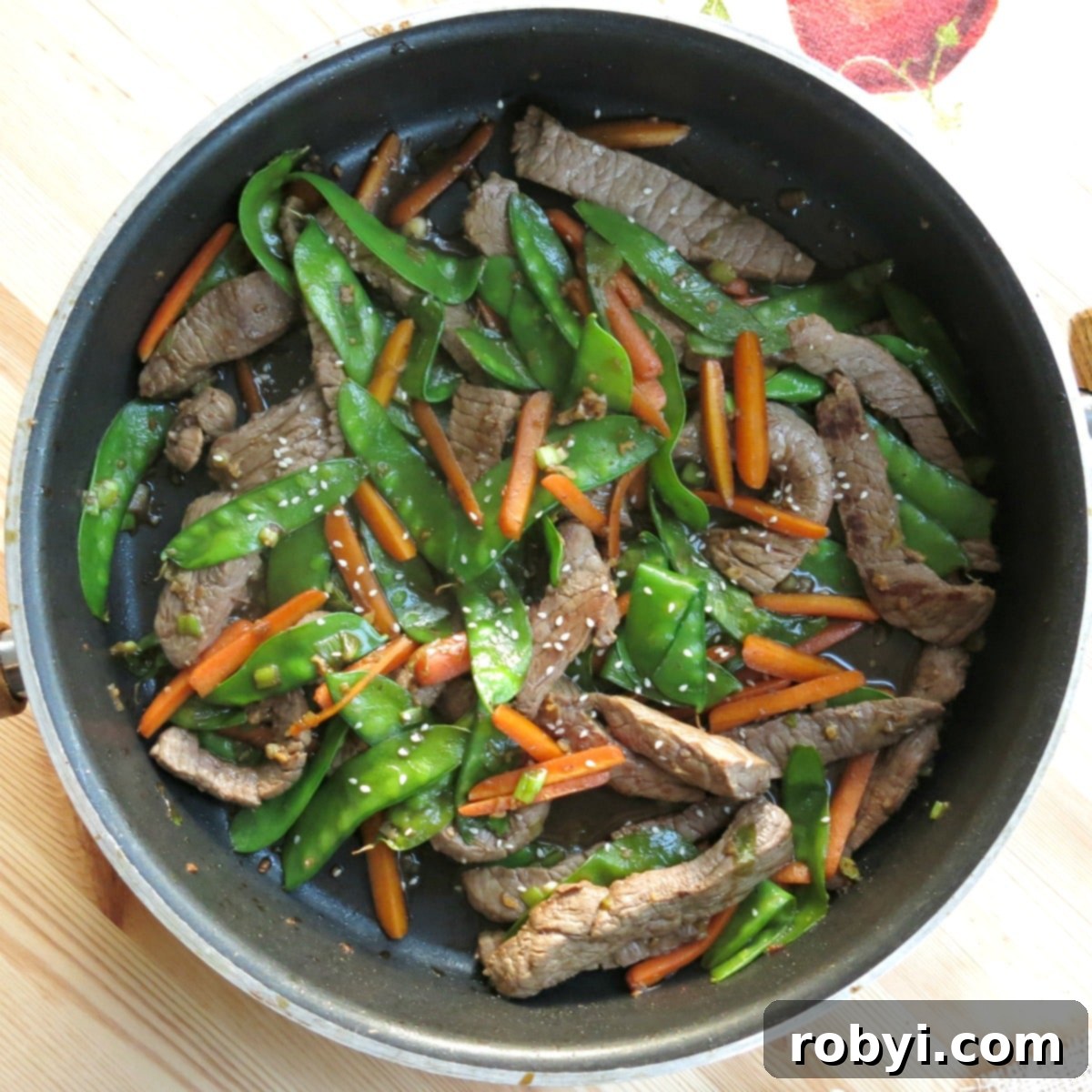 Asian beef stir fry in skillet.