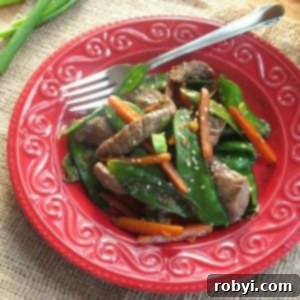 Sesame beef stir fry on plate with fork