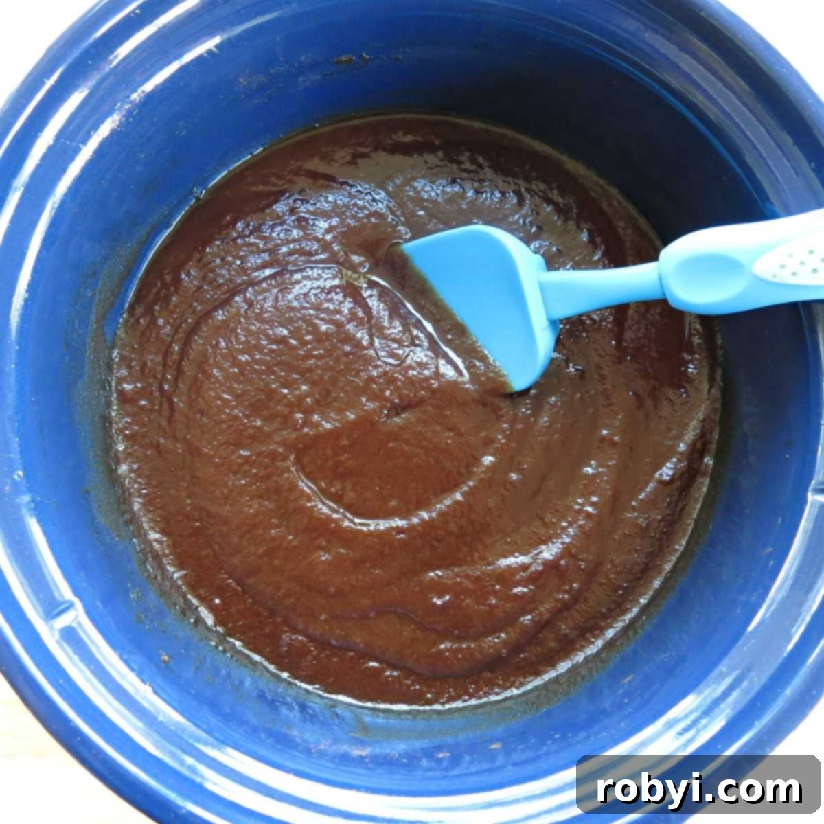Naturally Sweet Slow Cooker Apple Butter 4 Smooth, healthy sugar-free apple butter in a slow cooker, ready to be jarred.