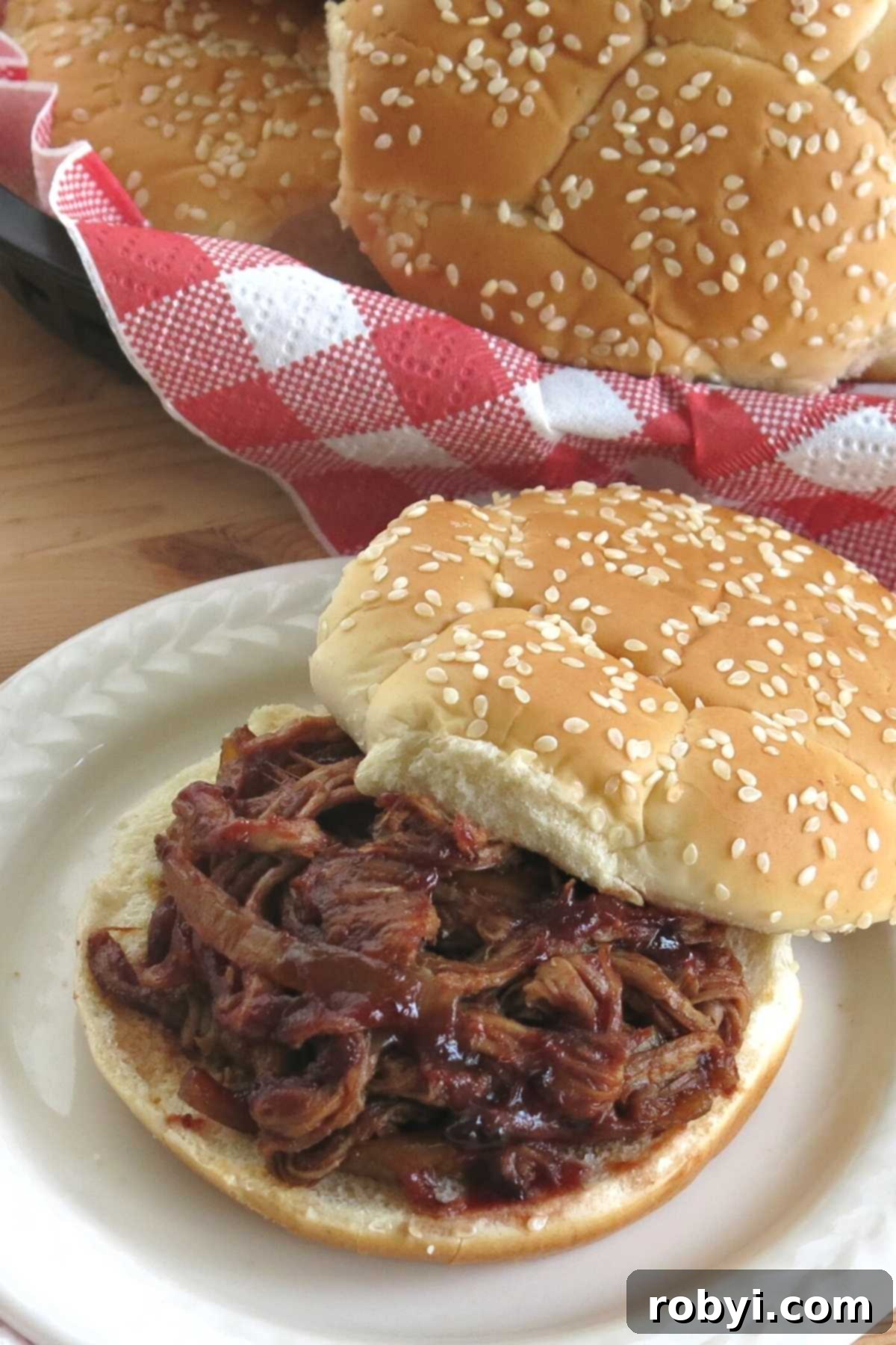 Sweet and Tangy Blackberry Slow Cooker Pulled Pork Tenderloin 5 Crock-pot pulled pork tenderloin on a bun.
