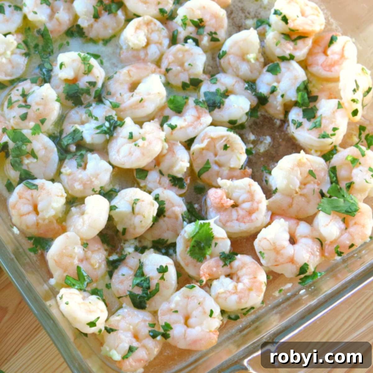 Costco Copycat Cilantro Lime Shrimp in a serving dish, garnished with fresh cilantro and lime wedges.