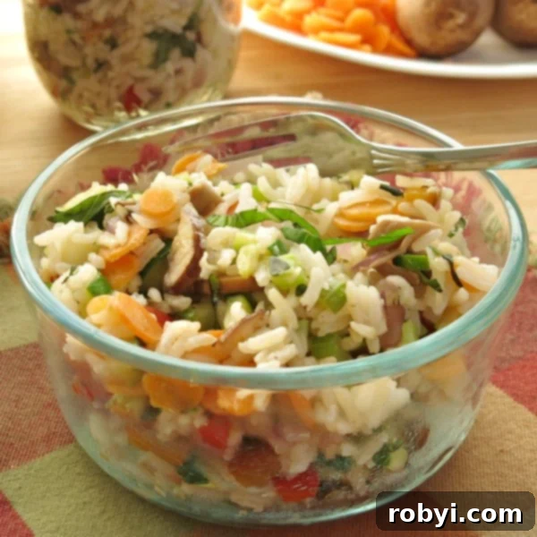 Vegetable Rice Pilaf Recipe in glass bowl with fork.
