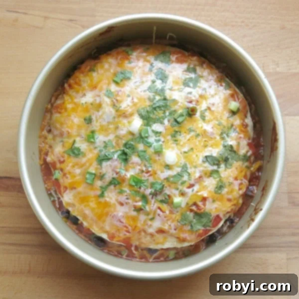 Fiesta Layered Burrito Bake 3 cooked stacked burrito pie casserole in a round pan