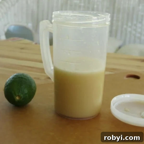 Honey Lime Dressing in a glass jar, showing its golden hue and smooth texture.