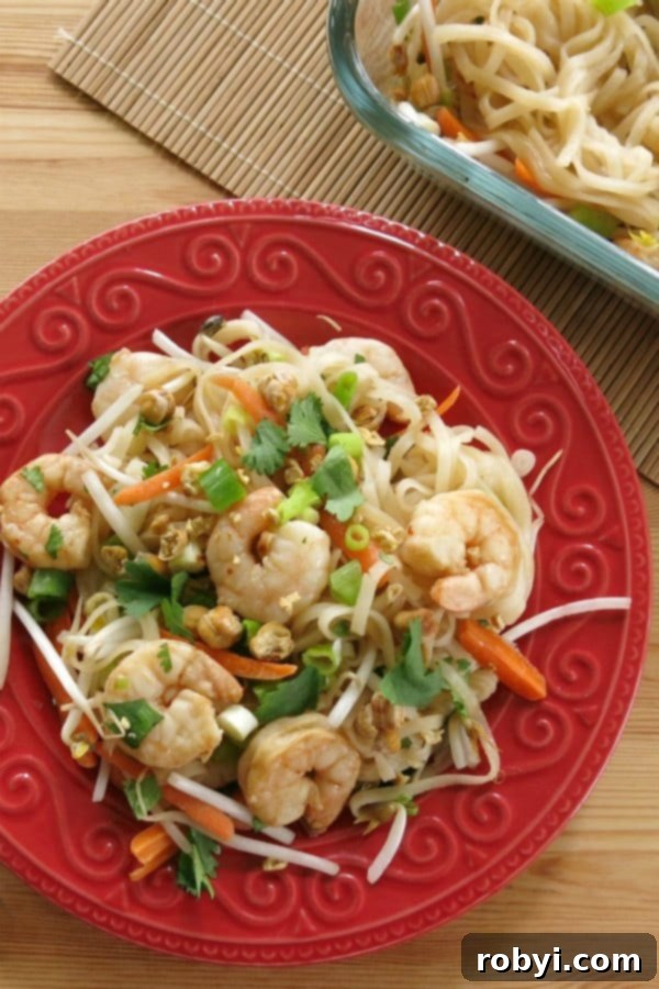 Overhead view of easy shrimp pad thai recipe on plate with baking dish in background
