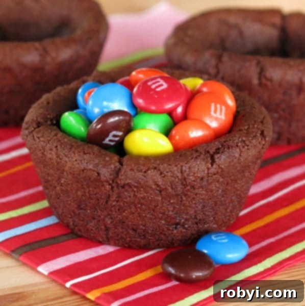 A tempting Double Chocolate Chip Cookie Cup filled to the brim with colorful M&M's candies, showcasing a vibrant and playful dessert option.
