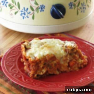 Slice of crock-pot vegetable lasagna on a plate in front of a slow cooker.