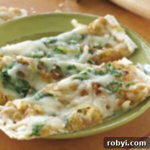 Two slices of pumpkin pizza featuring creamy pumpkin pizza sauce, caramelized onions, and spinach.