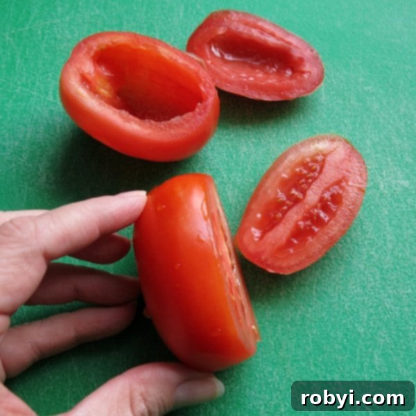 Easy Four Ingredient Rice Stuffed Tomatoes 4 Hulled Roma Tomatoes prepared for stuffing, showing the sliced tops