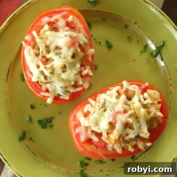 Easy Four Ingredient Rice Stuffed Tomatoes 6 Baked Stuffed Tomatoes with Rice and Sausage on a serving plate, garnished