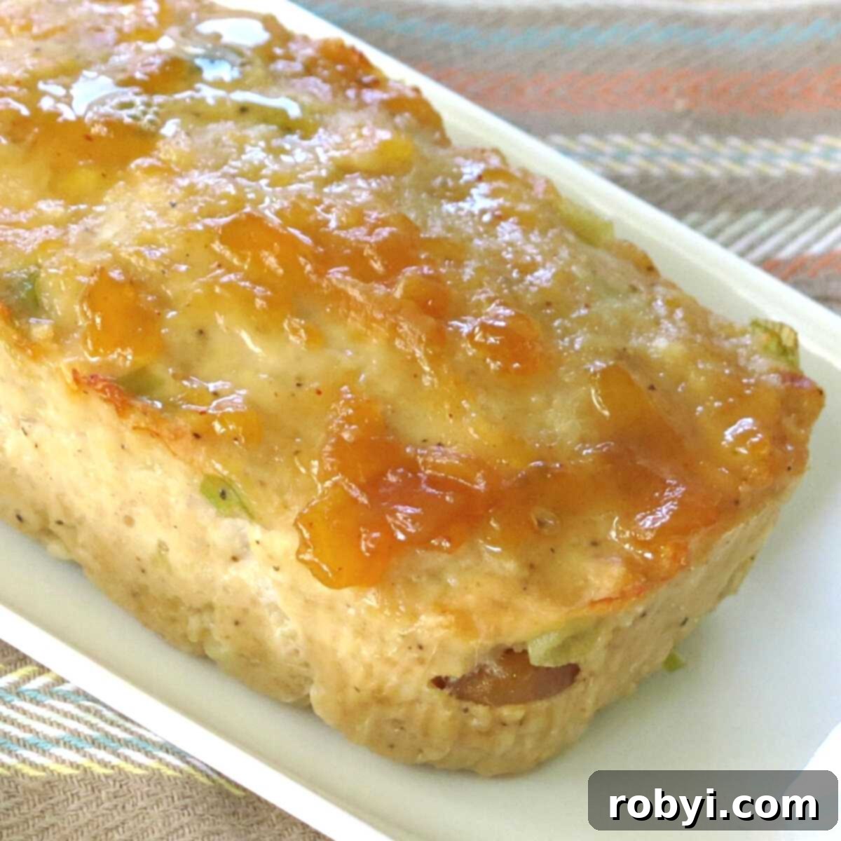 Southwest Turkey Meatloaf Muffins 5 A cooked ground turkey loaf topped with salsa and garnished on a platter, showcasing an alternative presentation.