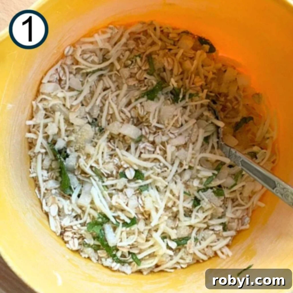 Dry ingredients mixed together in a large bowl, including oats, cheese, onions, basil, and sun-dried tomatoes.